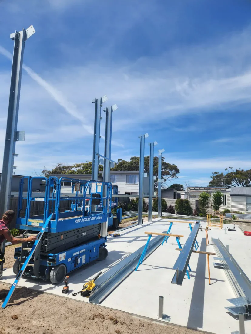 Steel members laid out across the finished concrete slab at Weymouth, ready to be raised
