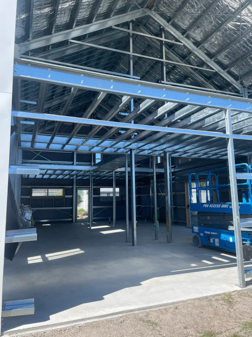 The steel mezzanine floor framing installed inside the portal frame, seen from the ground floor