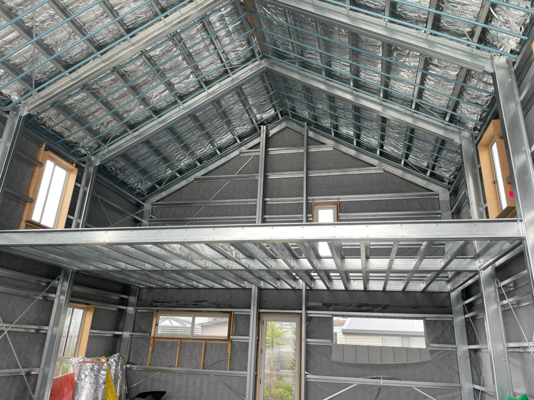 Inside Shed Home #03 at lock-up with the mezzanine deck down and windows installed