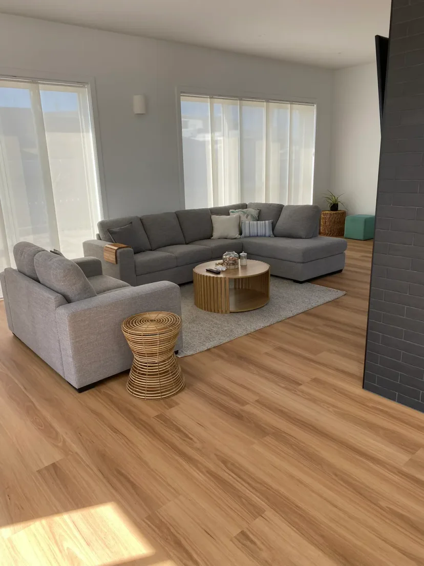 The furnished living room of the finished home with the fireplace wall